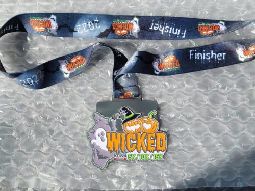 Kona Running Company finisher medal and ribbon for the wicked run